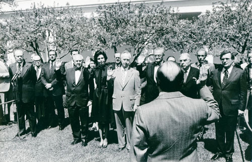 (L to R) President Gerald R. Ford, Commissioners Thomas B. Curtis, Joan D. Aikens, Vernon W. Thomson, Thomas E. Harris, Neil O. Staebler, and Robert O. Tiernan